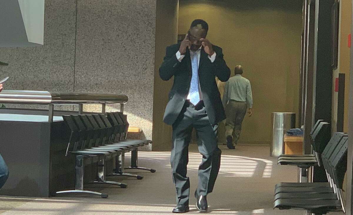 Calvin Walker talks on the cell phone after his probation hearing.