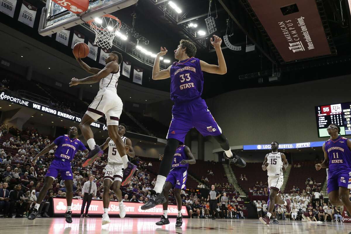 Texas A&M guard Wendell Mitchell (11) gets past Northwestern State guard Nikos Chougkaz (33) for a basket during the second half of an NCAA college basketball game Wednesday, Nov. 6, 2019, in College Station, Texas. (AP Photo/Sam Craft)