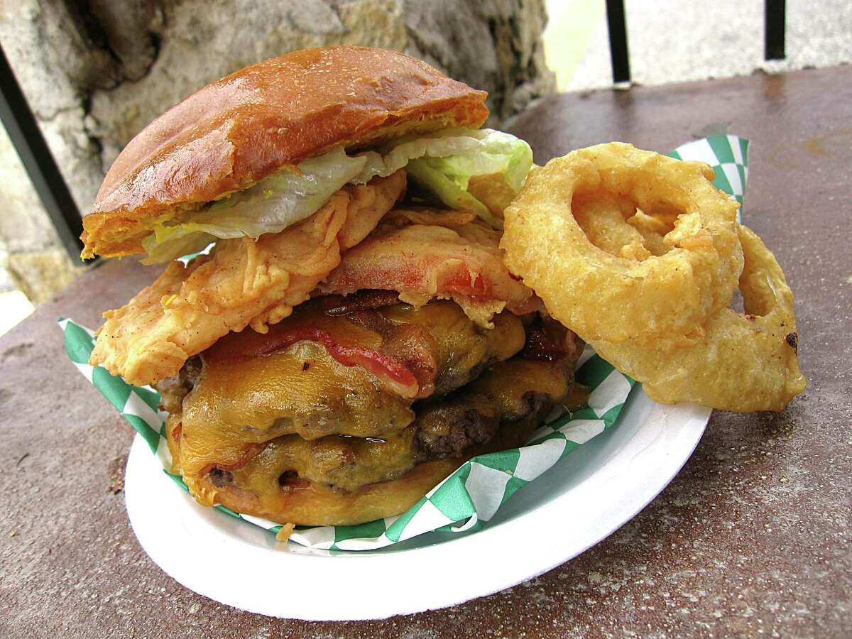 A double third-pound burger with bacon, cheddar and fried tomatoes can be ordered as a combo with a drink and a side of onion rings at Big Lou's Burgers & BBQ.