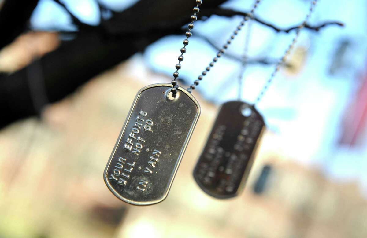 Dog tags made by students and community members and dedicated to specific service members , hang from a tree in the Quad area of the midtown campus of Western Connecticut State University in Danbury, Wednesday, Dec. 16, 2015. They were placed there during a Veterans Day ceremony in November. According to the university, the tree stands as a reminder of the bond the citizens of the United States share with the men and women of the Armed Forces.