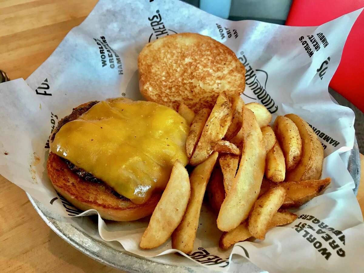 Basic cheddar cheeseburger with wedge fries at Fuddruckers