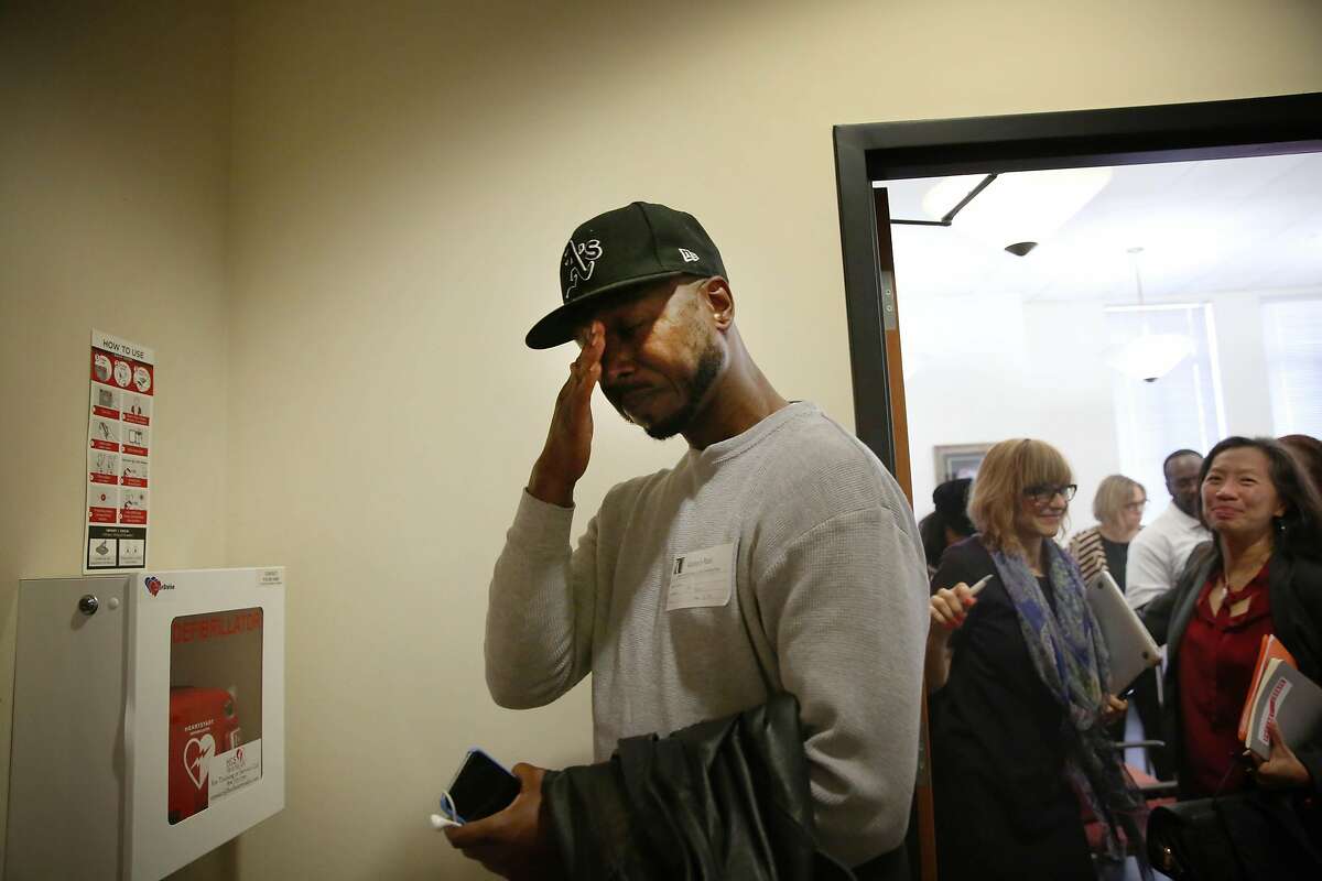 John Jones III (left), director of community and political engagement Just Cities and who was formerly incarcerated, wipes tears away as he leaves a the Berkeley City Council Land Use, Housing and Economic Development meeting after the committee voted to support an ordinance aimed at improving the quality of life for formerly incarcerated people that was discussed on Thursday, November 7, 2019 in Berkeley, Calif.