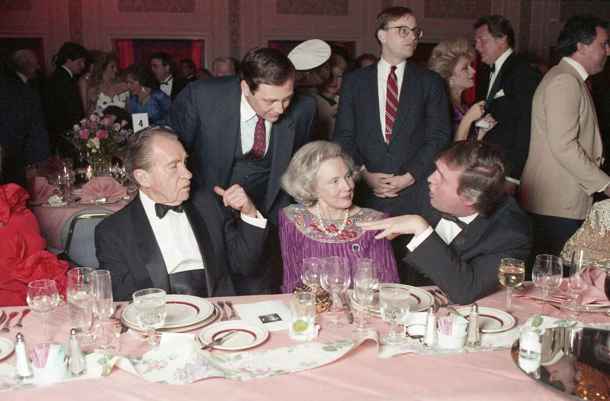 Former President Richard Nixon, from left, Nellie Connally and Donald Trump visit at a tribute gala to Connally at the Westin Galleria.