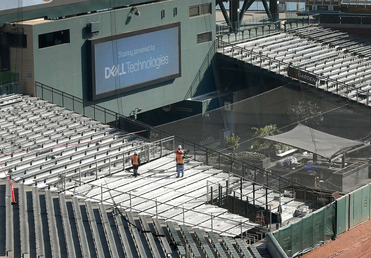 A construction crew dismantles a section of bleachers behind center field to possibly make room for the new bullpen at Oracle Park in San Francisco, Calif. on Thursday, Nov. 7, 2019.