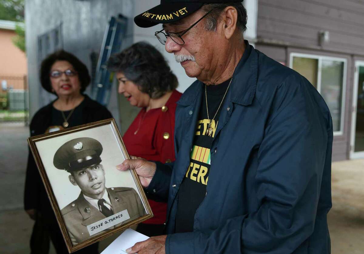 Vietnam veteran Jesse Torres, 75, arrives with his military portrait at a ceremony honoring military vets at the Good Samaritan Center on Thursday.
