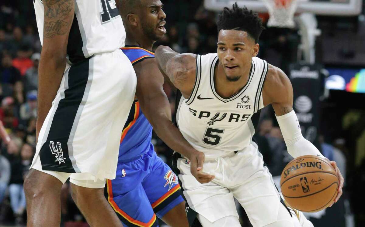 Dejounte Murray takes adavantage of a LaMarcus Aldridge screen to get away from Chris Paul as the Spurs hosts the Thunder at the AT&T Center on Nov. 7, 2019.