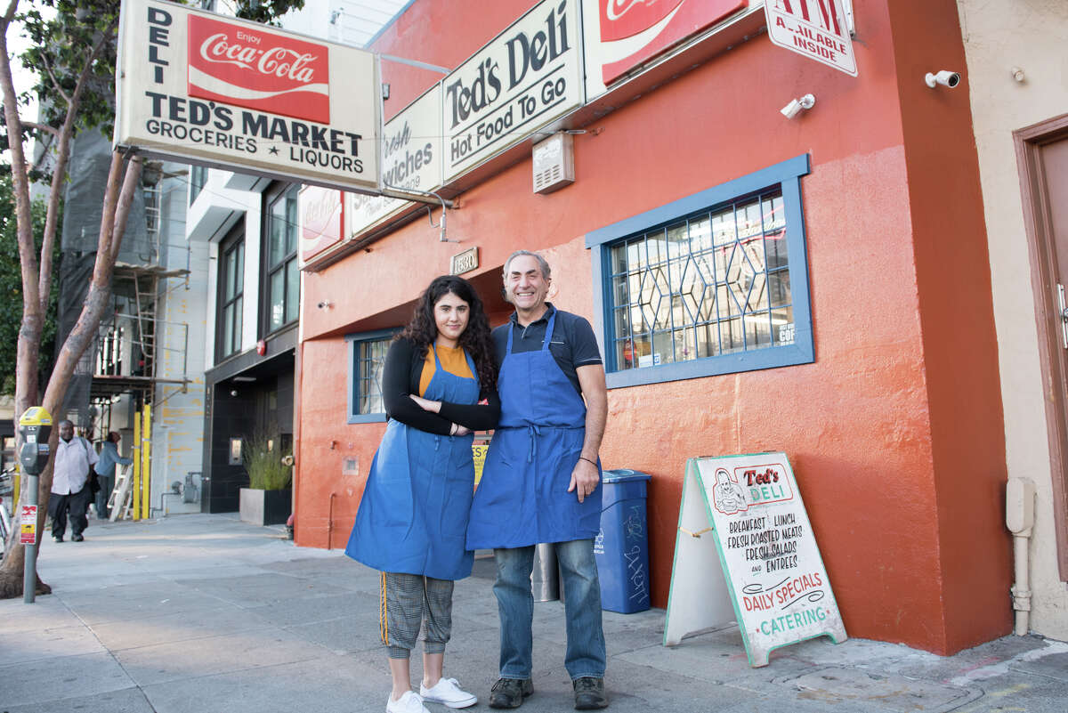 Miriam Zouzounis and her father David pose outside of Ted's Market, which has been serving the SoMa neighborhood since 1967.