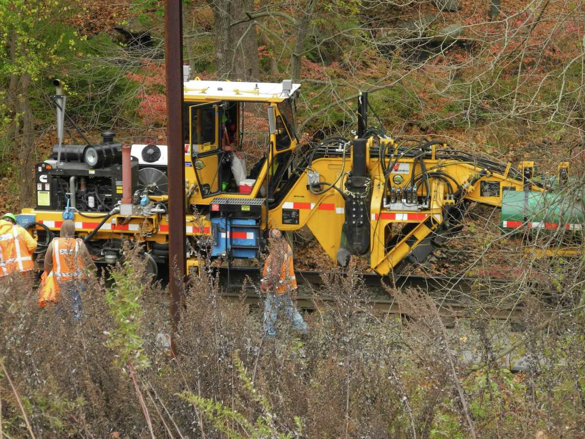 Rail workers replace railroad ties along the Danbury branch line in Wilton, Conn., on Nov. 7.