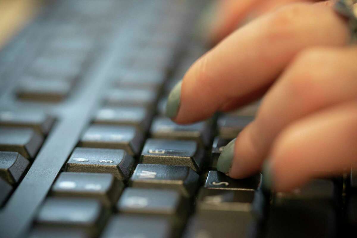 In this Tuesday, Oct. 8, 2019, photo a woman types on a keyboard in New York. (AP Photo/Jenny Kane)
