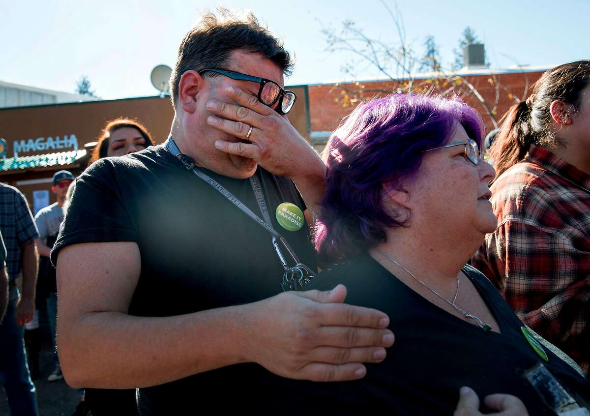 Kevin MacDonald and Maggie MacDonald cry as they listen to speakers during the opening ceremony of the Building Resiliency Center and commemoration of the one year anniversary of the devastating Camp Fire in Paradise, Calif. Friday, Nov. 8, 2019.