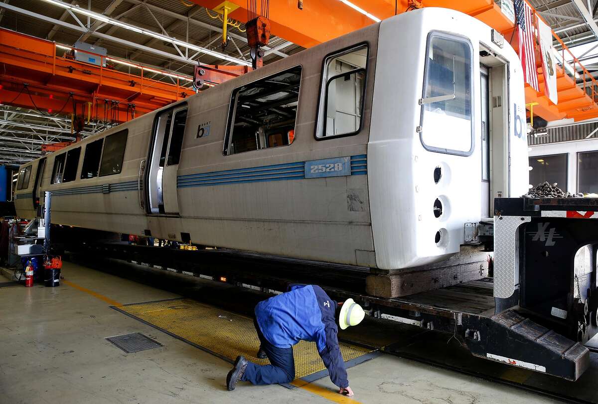 A shell of its former, gleaming self, BART car of the past rolls to