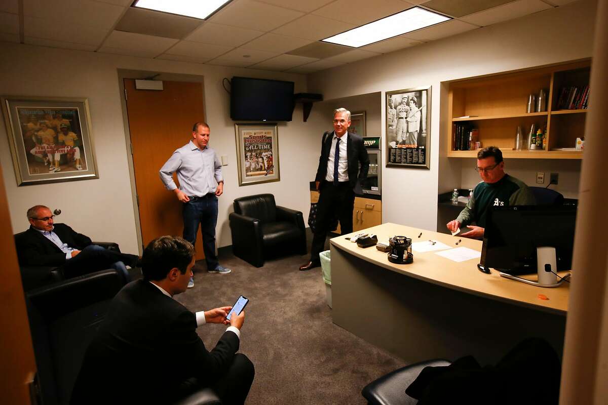 NEW YORK, NY - OCTOBER 3: President David Kaval, Assistant General Manager, Pro Scouting & Player Personnel Dan Feinstein, General Manager David Forst, Executive Vice President of Baseball Operations Billy Beane and Manager Bob Melvin #6 of the Oakland Athletics sit in the managers office in the clubhouse following the game against the New York Yankees in the American League Wild Card Game at Yankee Stadium on October 3, 2018 New York, New York. The Yankees defeated the Athletics 7-2. Zagaris/Oakland Athletics/Getty Images)