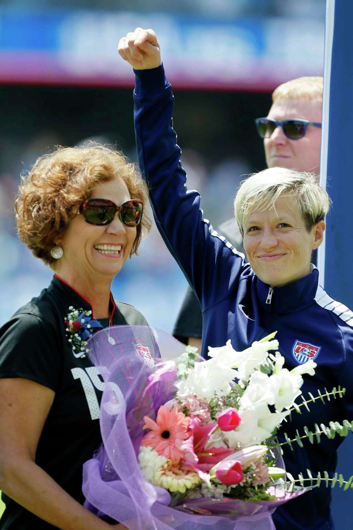 Soccer star Megan Rapinoe of the United States points to her mom, Denise Rapinoe, on Mother's Day during introductions before a friendly match against Ireland on Mother's Day May 10, 2015 at Avaya Stadium in San Jose, California.
