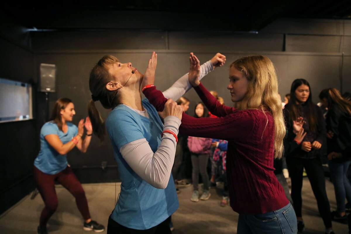 Stephanie Cyr (left), owner of Edge Self Defense, partners with Stephanie Mohr, 12, of Sacramento, as they perform a self defense move during a demonstration at the 4th annual Girls Festival at the Palace of Fine Arts in San Francisco, Calif., on Saturday, November 9, 2019. The event was designed to inspire girls to follow their dreams and do whatever they choose. "It's thirty minutes. I want to get something in their heads that they'll remember," Cyr said, who's been doing martial arts for nearly thirty years. "I want everyone to learn their inner power." Mohr adds, "It felt weird because you don't do it everyday, but it's nice getting to learn stuff that can help defend you."