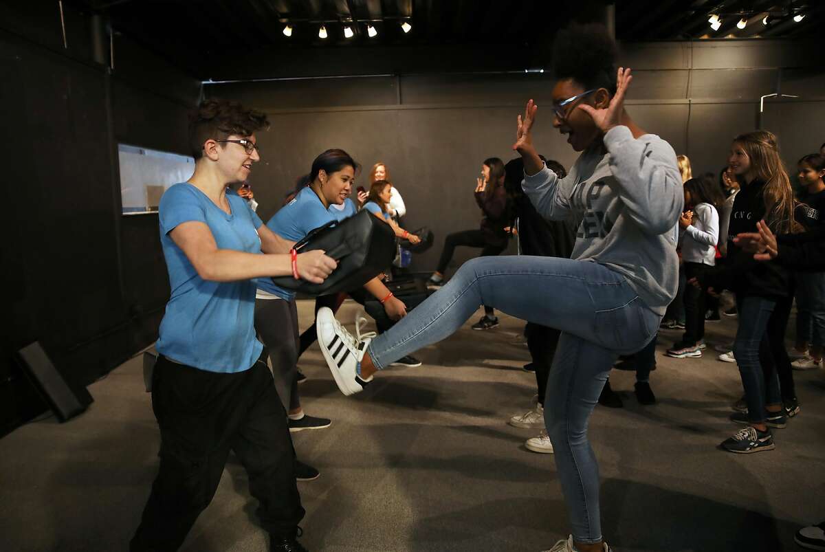 Sam Hengesbach, a teaching assistant with Edge Self Defense, holds a pad as Iris Shavies, 13, an eighth grade student at Antioch Middle School, kicks it during a self defense demonstration during the 4th annual Girls Festival at the Palace of Fine Arts in San Francisco, Calif., on Saturday, November 9, 2019. The event was designed to inspire girls to follow their dreams and do whatever they choose. "Today was to empower the girls, empower the voices," Hengesbach said.