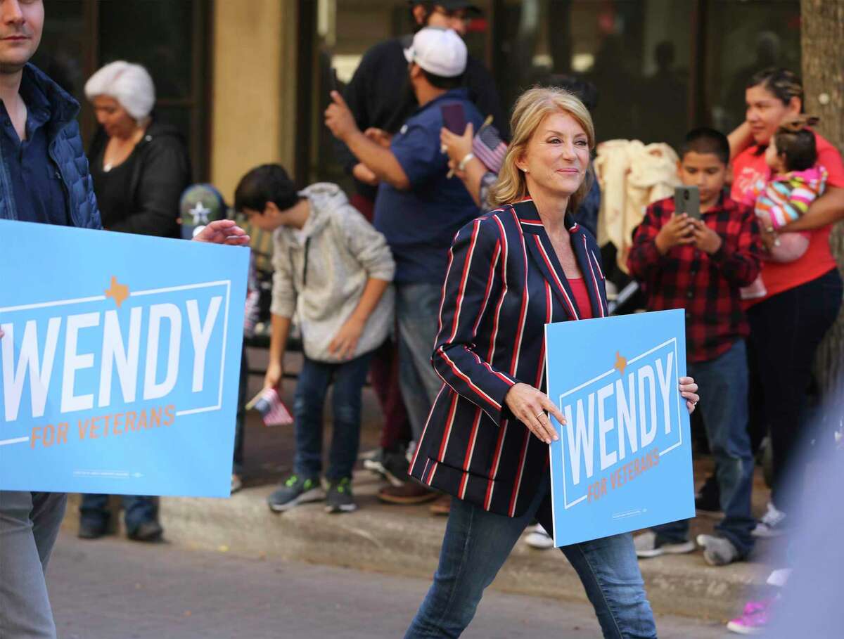 Wendy Davis, the former Texas senator now running for U.S. Congress, takes part in the U.S. Veterans Day Parade Association's 20th annual Veterans Day parade through downtown San Antonio on Saturday, Nov. 9, 2019. Prior to the parade, a wreath presentation honoring veterans from all military branches including a flyover of a C-5 aircraft from the 433rd Airlift Wing occurred at the Alamo. About 100 parade entries, including floats and bands and cars took part in the celebration that started by the Express-News building and finished by Milam Park where a festival with vendors took place. (Kin Man Hui/San Antonio Express-News)