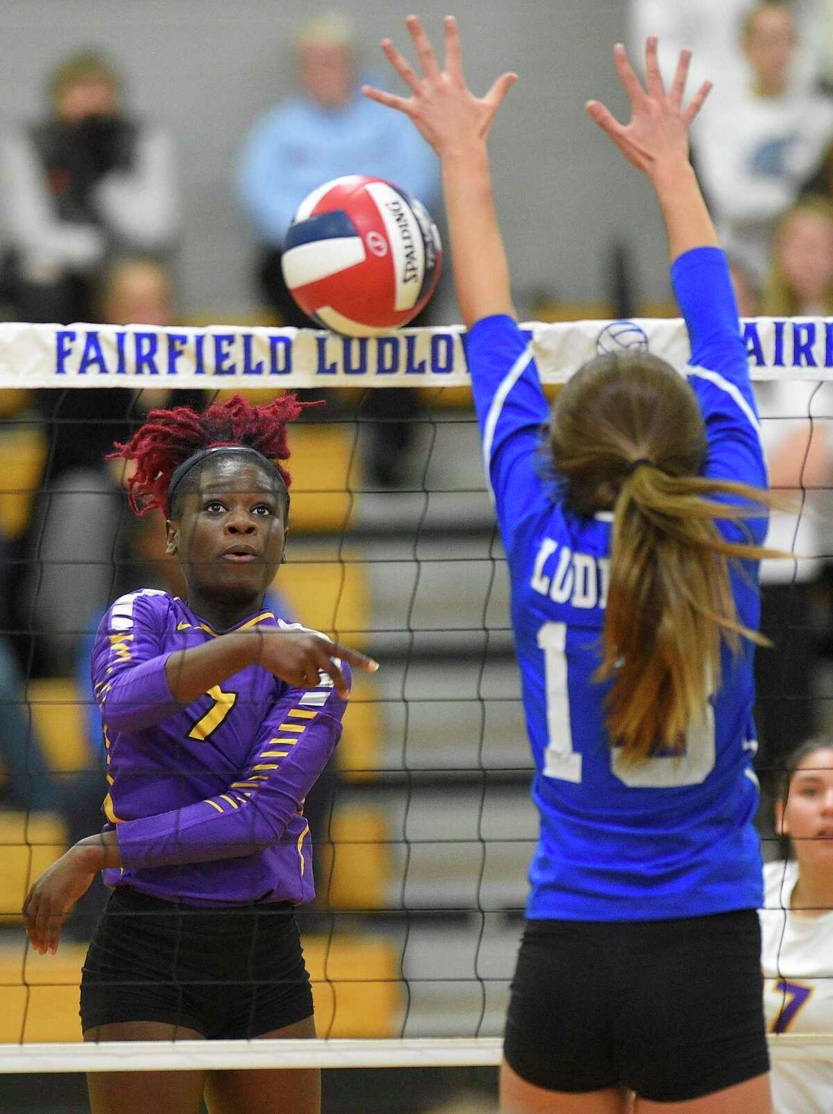 Westhill's Gloria Twum (7) hits a hard shot past Fairfiled Ludlowes Jo Blanco. Fairfield Ludlowe won the 5th set 15-9 to take the FCIAC volleyball championship 3-2 over Westhill on Nov. 9, 2019 in Fairfield, Connecticut.