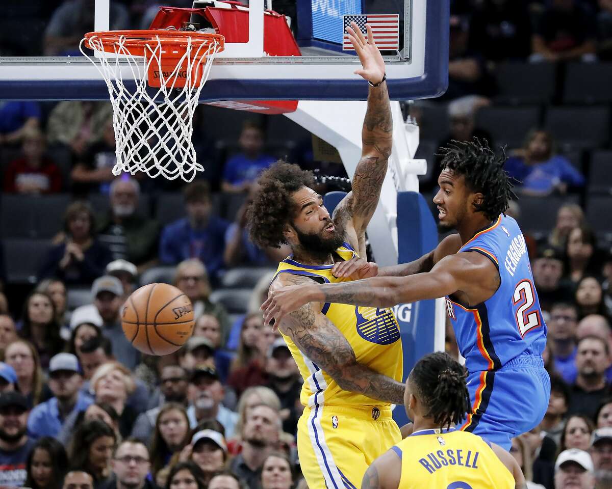 Oklahoma City Thunder's Shai Gilgeous-Alexander (2) passes the ball away from Golden State Warriors' Willie Cauley-Stein (2) and D'Angelo Russell (0) during the first half of an NBA basketball game in Oklahoma City, Saturday, Nov. 9, 2019. (AP Photo/Garett Fisbeck)