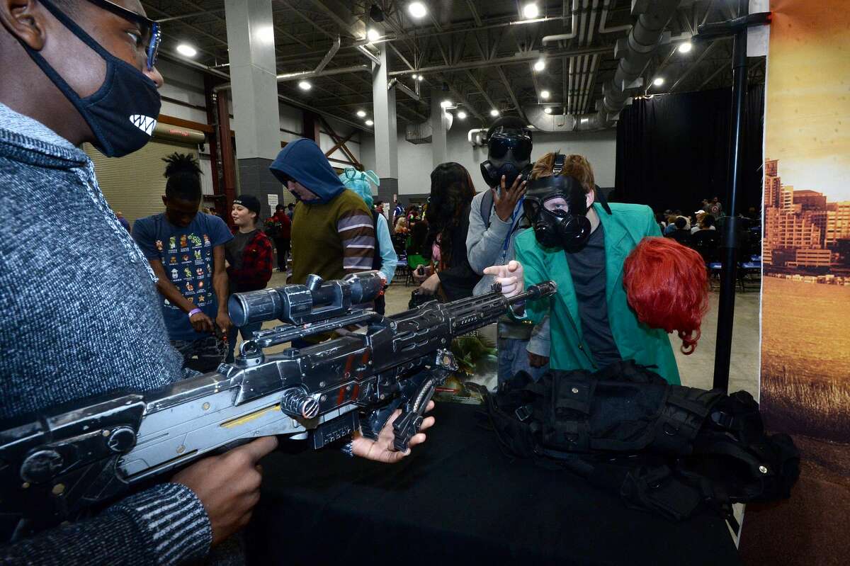 Noriaki Kakyoin jokes with another event goer while checking out the toy guns at Beaumont's first Comic Con gathering Saturday at Ford Park. Cosplayers, comic book fans and more filled the arena, taking in presentations and vendors offering items ranging from classic comics and collectibles to present day characters. The event continues Sunday. Photo taken Saturday, November 9, 2019 Kim Brent/The Enterprise