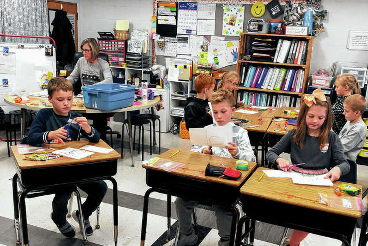Mrs. Sichting’s students Corbin Arnold (front), Brealyn Kruger (second row, from left) and Carter McMillan enjoy their pumpkin pie treat.