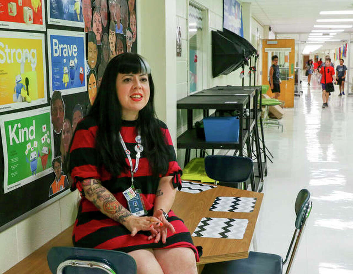 Jen Leban, a sixth- through eighth-grade creative technology teacher at Sandburg Middle School in Elmhurst, waits for students outside her classroom.