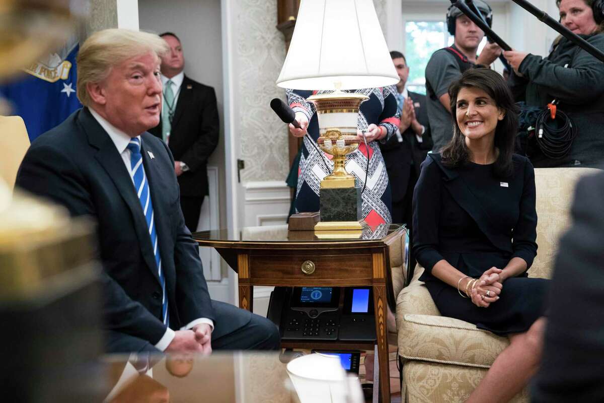 Then-U.S. Ambassador to the United Nations Nikki Haley listens as President Donald Trump speaks during a meeting with UN Secretary General Antonio Guterres in the Oval Office of the White House in October 2017.
