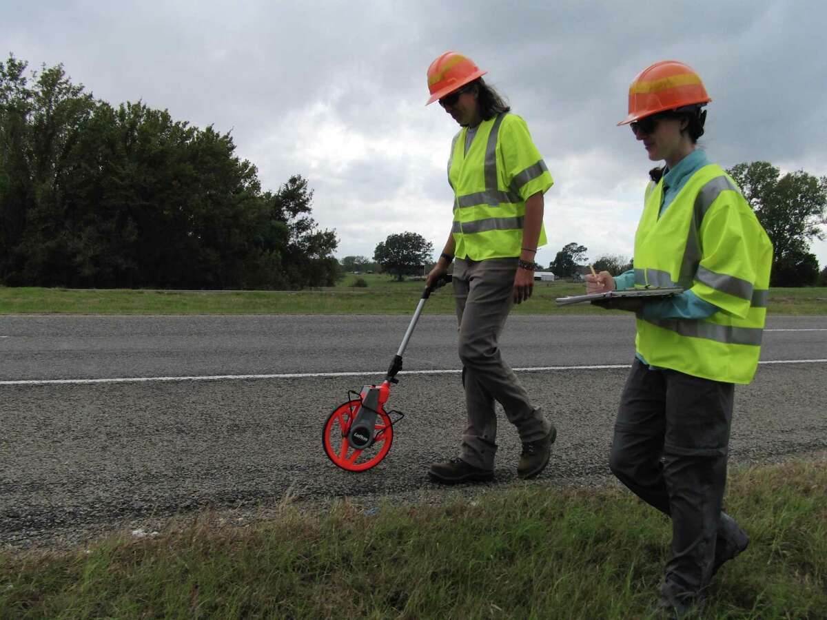 Janice Bovankovich (left) and Kaitlin Lopez (right) walking 100-meter monarch roadkill transect on Texas Highway 47, College Station, Texas on Oct. 28, 2019.