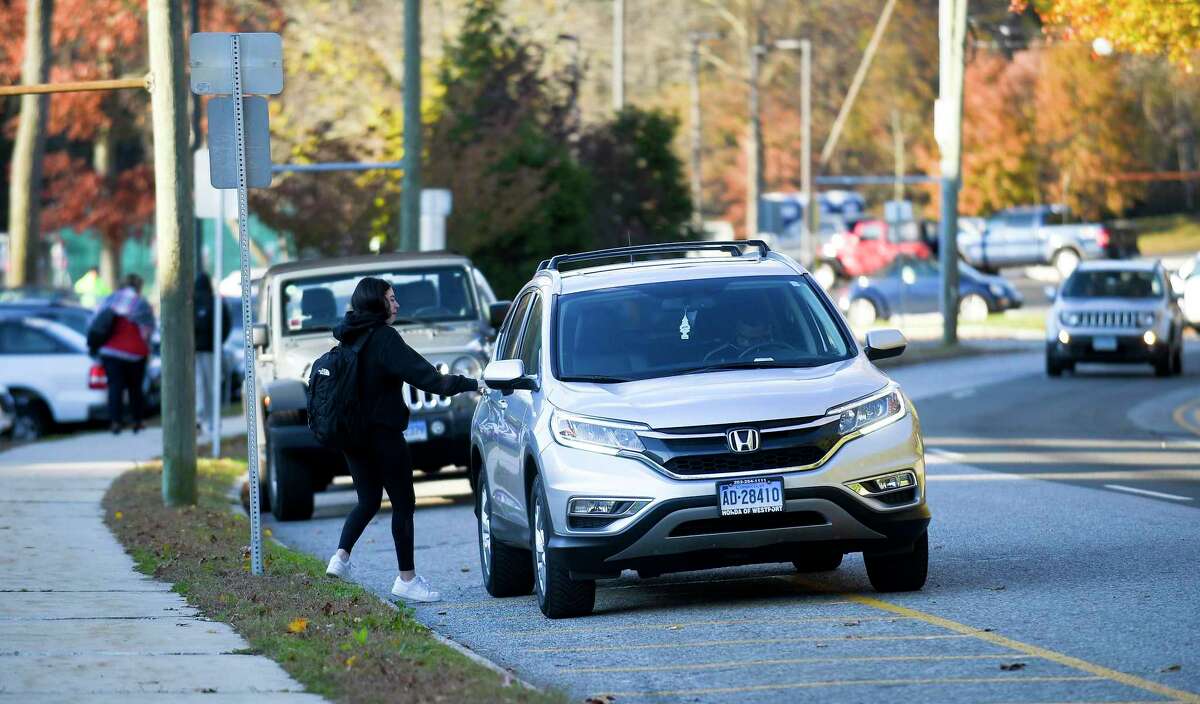 A Greenwich High School student hops into an Uber ride at dismissal on Nov. 8, 2019 in Greenwich, Connecticut.