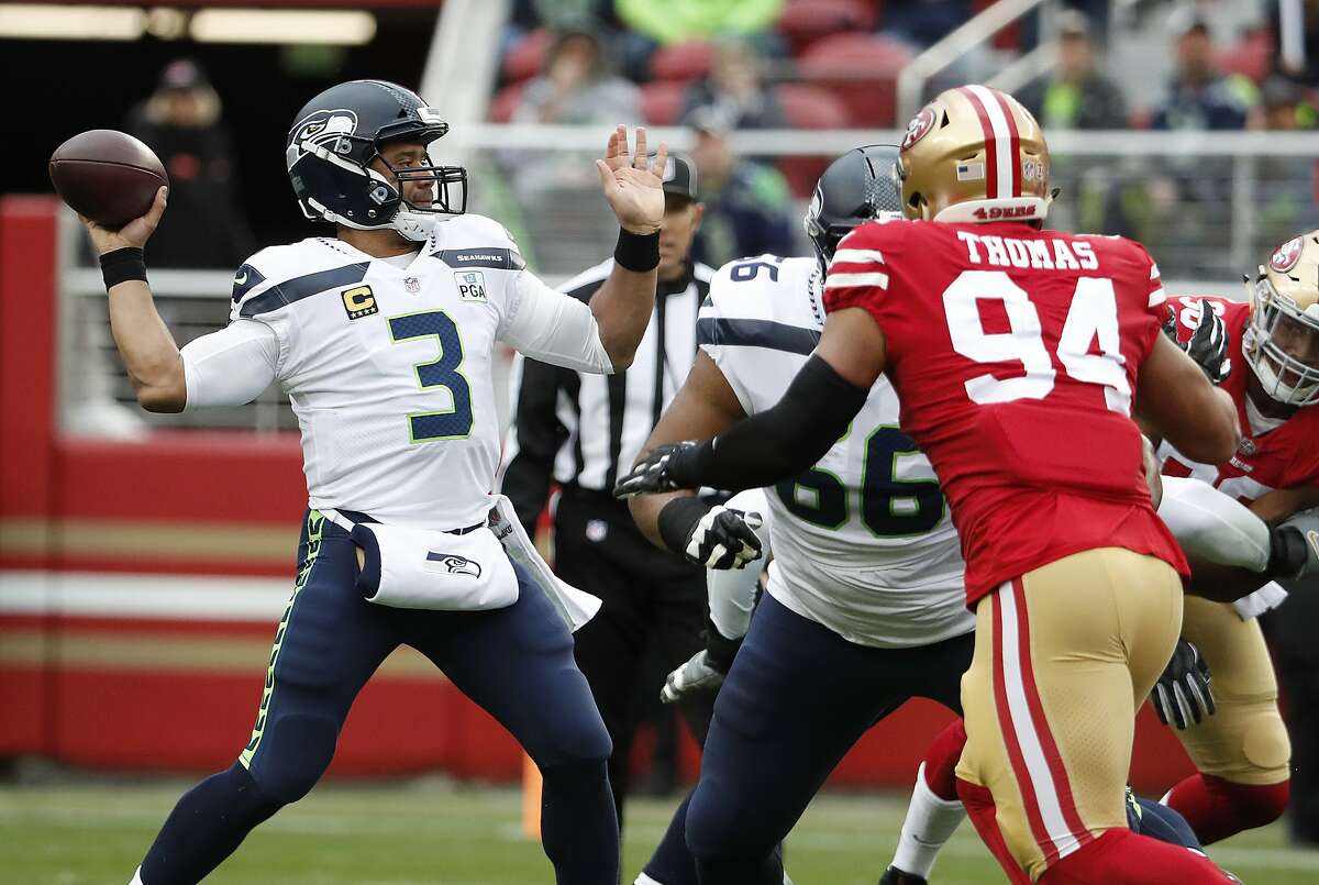 Russell Wilson of the Seattle Seahawks looks to pass against the San