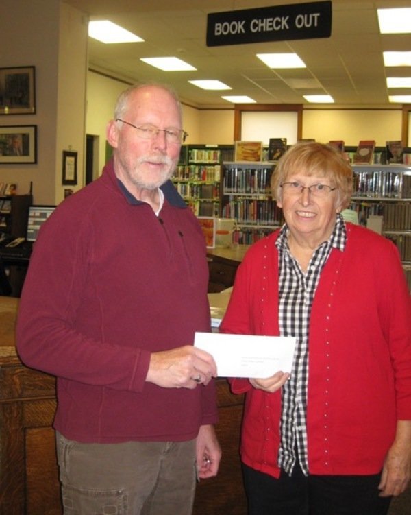 Men Who Care donate to Manistee Friends of the Library
