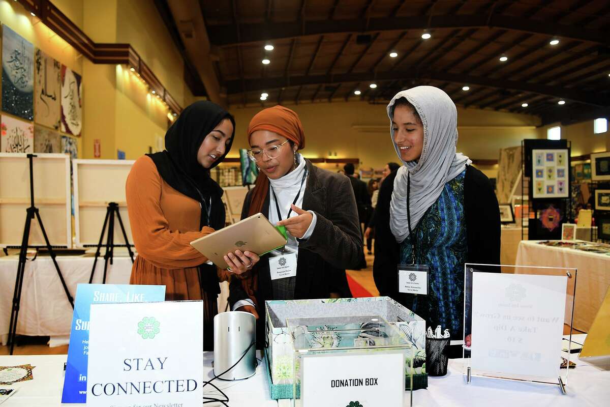 Fatima Khuram, from left, of The Woodlands and a student at the Univ. of Houston, Ruqaayia Najim, of Willowbrook and a student at the Univ. of Houston, and Sewar Almasalha, of Spring and a student at Texas A&M Univ., coordinate the social media during the Islamic Arts Festival at Masjid AlSalaam in Spring on Nov. 9. 2019.