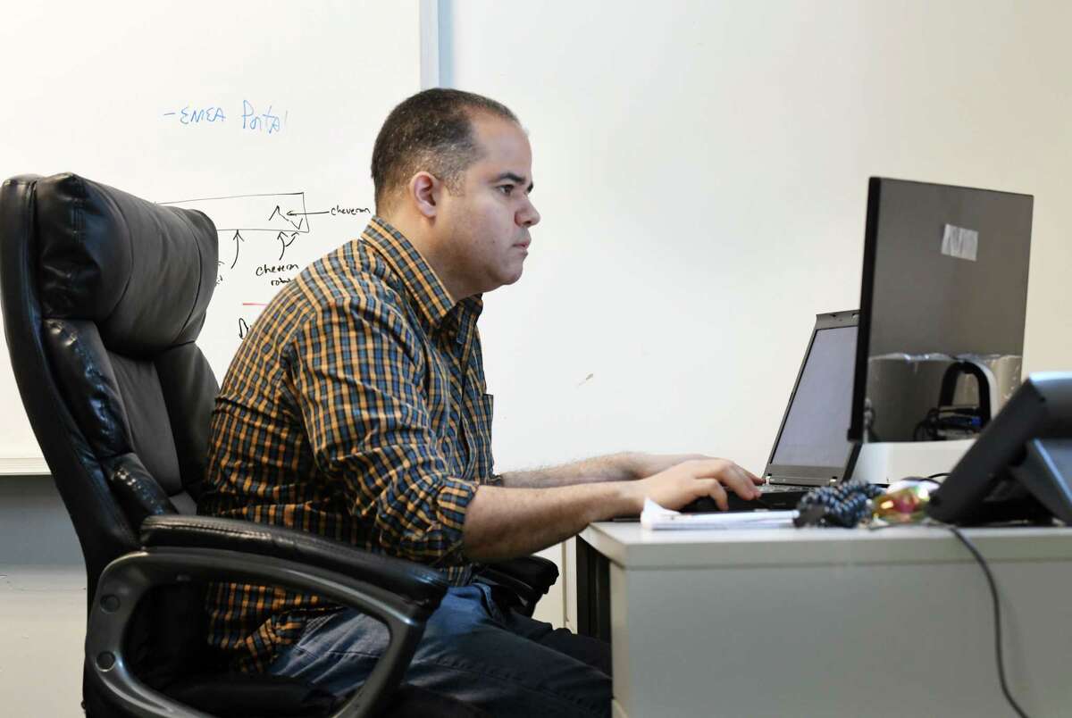 Air Force veteran Ramon Vazquez writes Javascript programming for UPPmarket on Monday, Nov. 11, 2019, at their Frear Building office in Troy, N.Y. Vazquez learned computer programming after taking classes through AlbanyCanCode, a Troy nonprofit group that organizes computer programming classes at local community colleges. AlbanyCanCode is now known as CanCode Communities. (Will Waldron/Times Union)