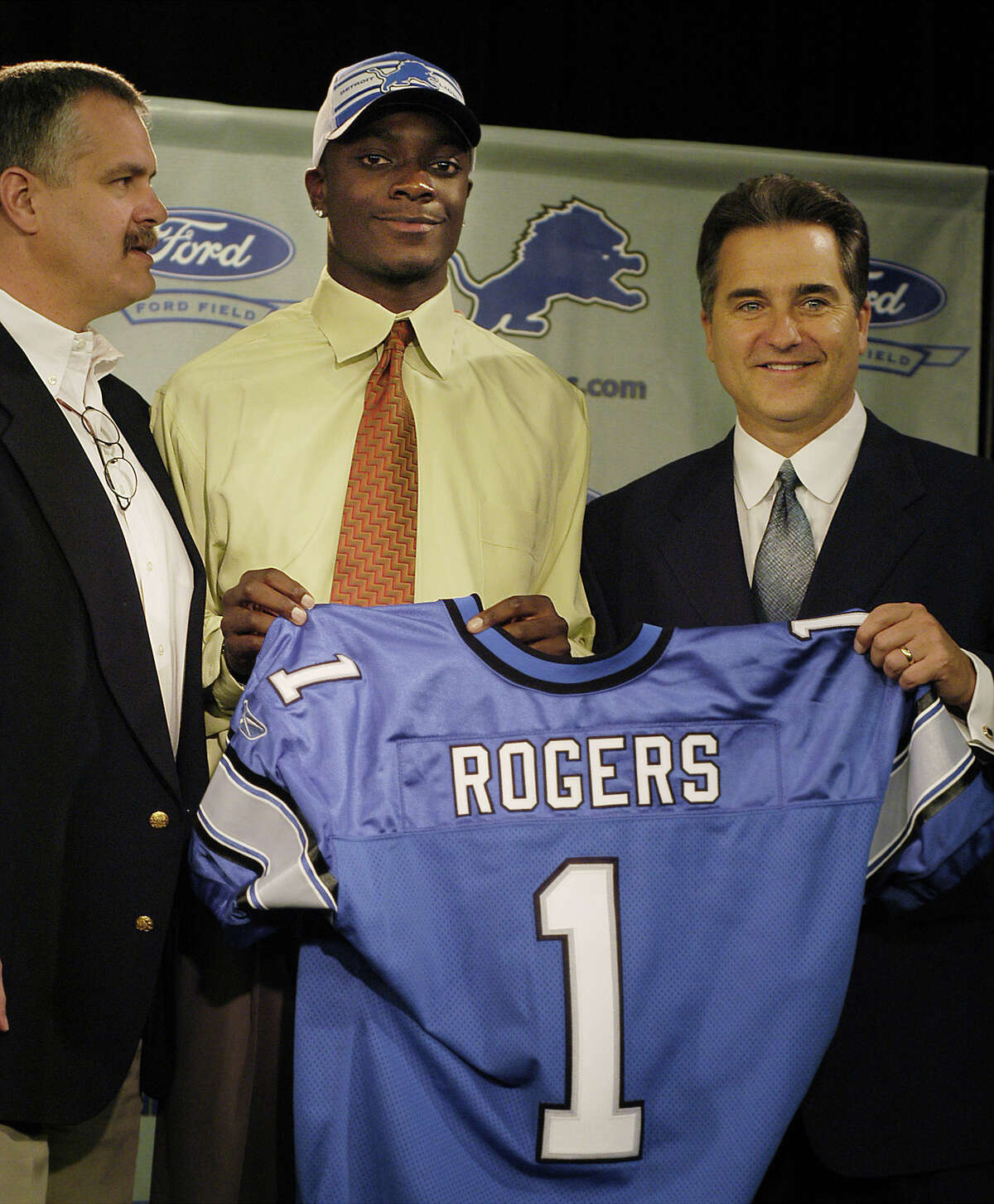 Detroit Lions president and chief executive officer Matt Millen, left, and Lions head coach Steve Mariucci, right, pose with Charles Rogers, the team's first round draft choice, during a press conference on Sunday, April 27, 2003 at the Lion's practice facility in Allen Park, Mich. The wide receiver out of Michigan State was the second overall pick in the 2003 NFL draft on Saturday.