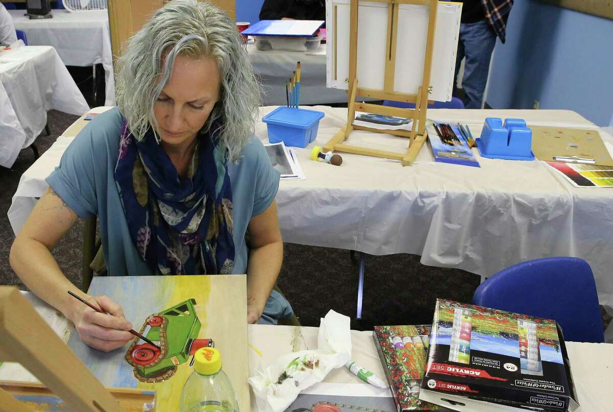 Sara McEathron works on a painting during a veterans' art class. The classes — offered by Bihl Haus’ Forward, Arts! program in partnership with Vet TRIIP — are taught in a portable classroom at St. Andrew Presbyterian Church.