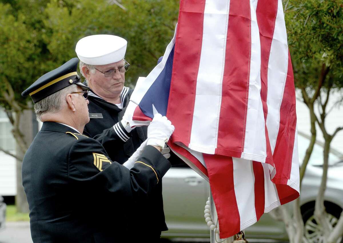 Southeast Texas Veterans Service Group members Don Hargroder (left) and Robert Rose post the colors during the annual Veterans Day program held Monday in Nederland's Veterans Park. Choral groups from Nederland High School and Helena Park Elementary performed during the event, and later joined in a reception at City Hall. Photo taken Monday, November 11, 2019 Kim Brent/The Enterprise