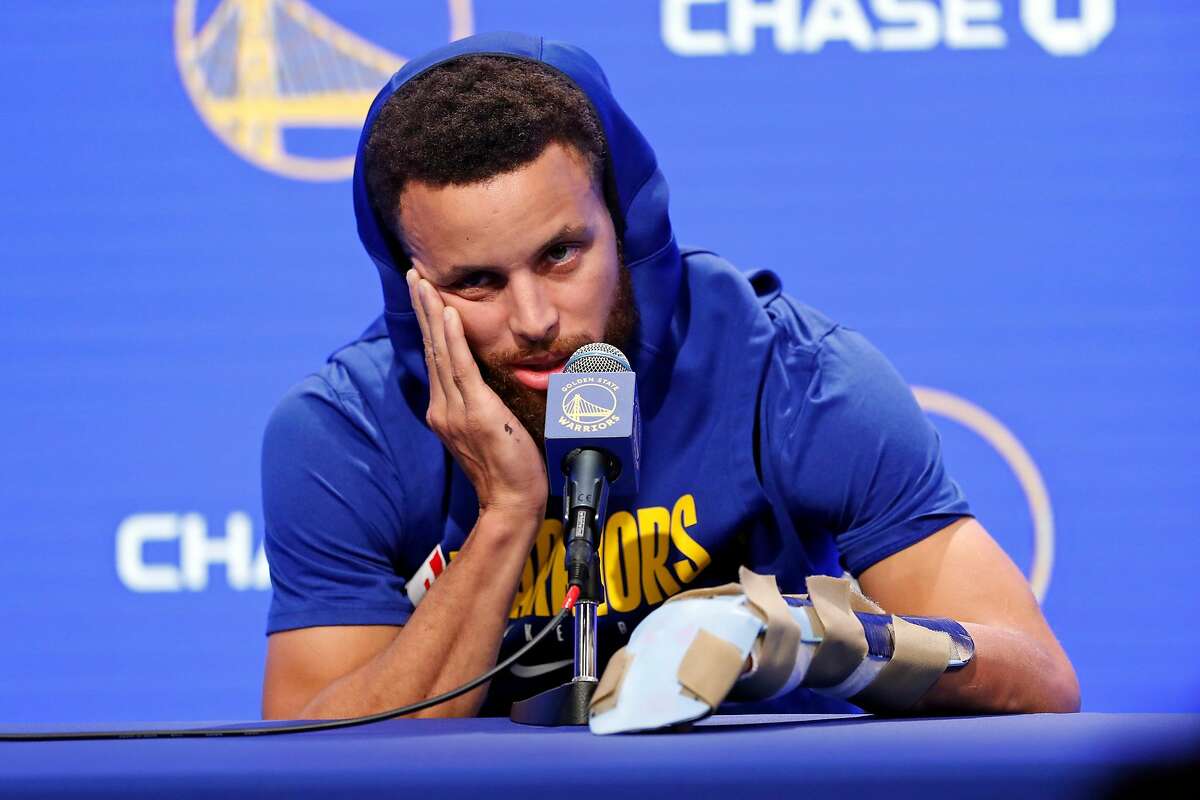 Golden State Warriors' Stephen Curry and his broken left hand during press conference before Warriors play Utah Jazz during NBA game at Chase Center in San Francisco, Calif., on Monday, November 11, 2019.