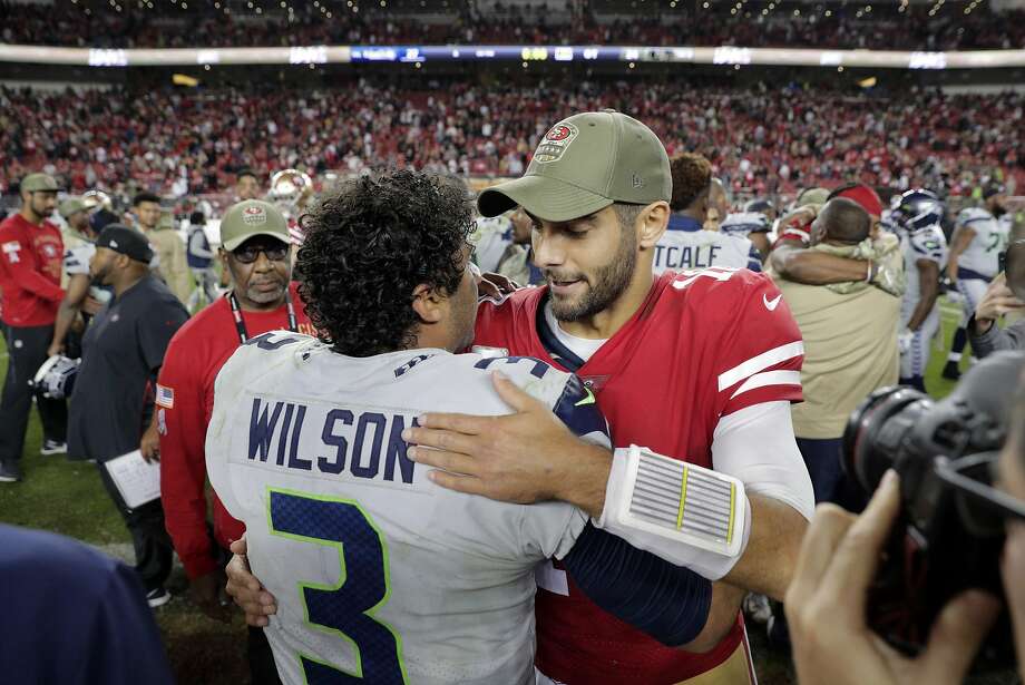 49ers quarterback Jimmy Garappolo congratulates the Seahawksu2019 Russell Wilson after the 49ers were defeated 27-24 in overtime by Seattle at Leviu2019s Stadiumon Nov. 11. Photo: Carlos Avila Gonzalez / The Chronicle
