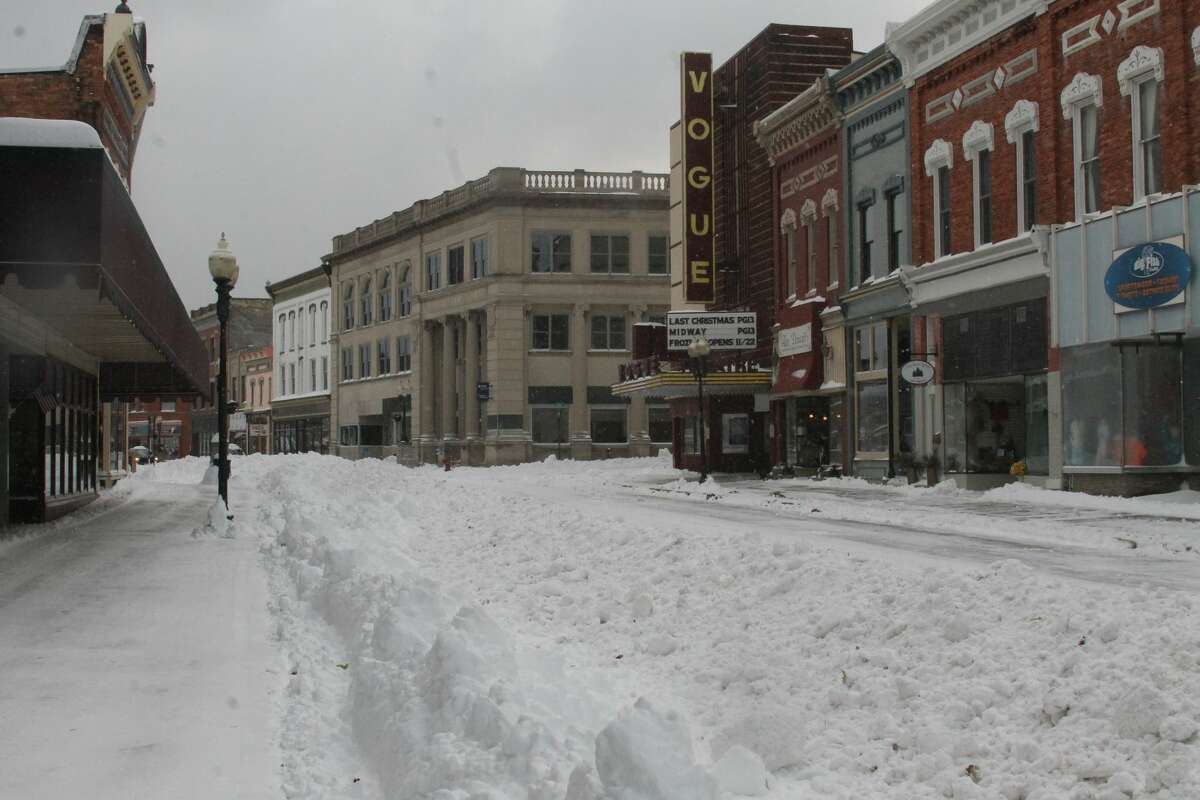 City of Manistee DPW workers and business owners worked to clear the downtown area on Tuesday morning after more than a foot of snow fell since Monday afternoon.