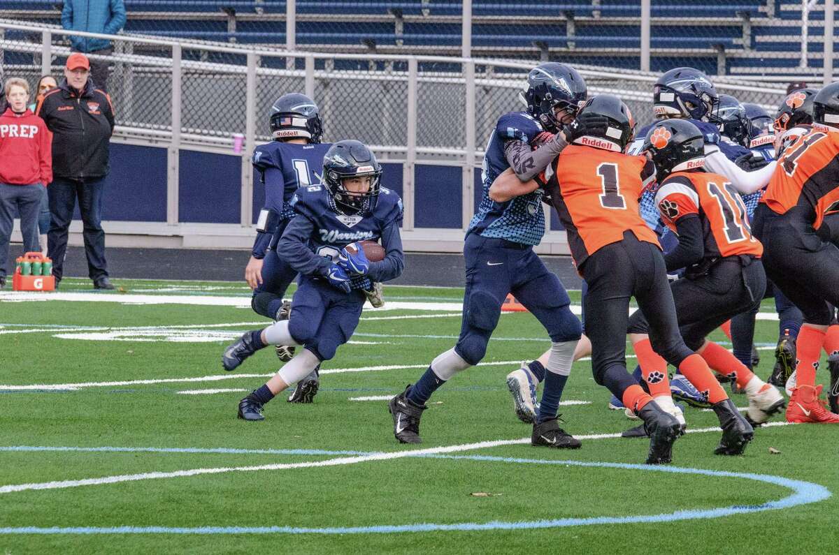 Jack Schwartz runs behind his offensive line during the Wilton seventh grade team's playoff win last weekend.