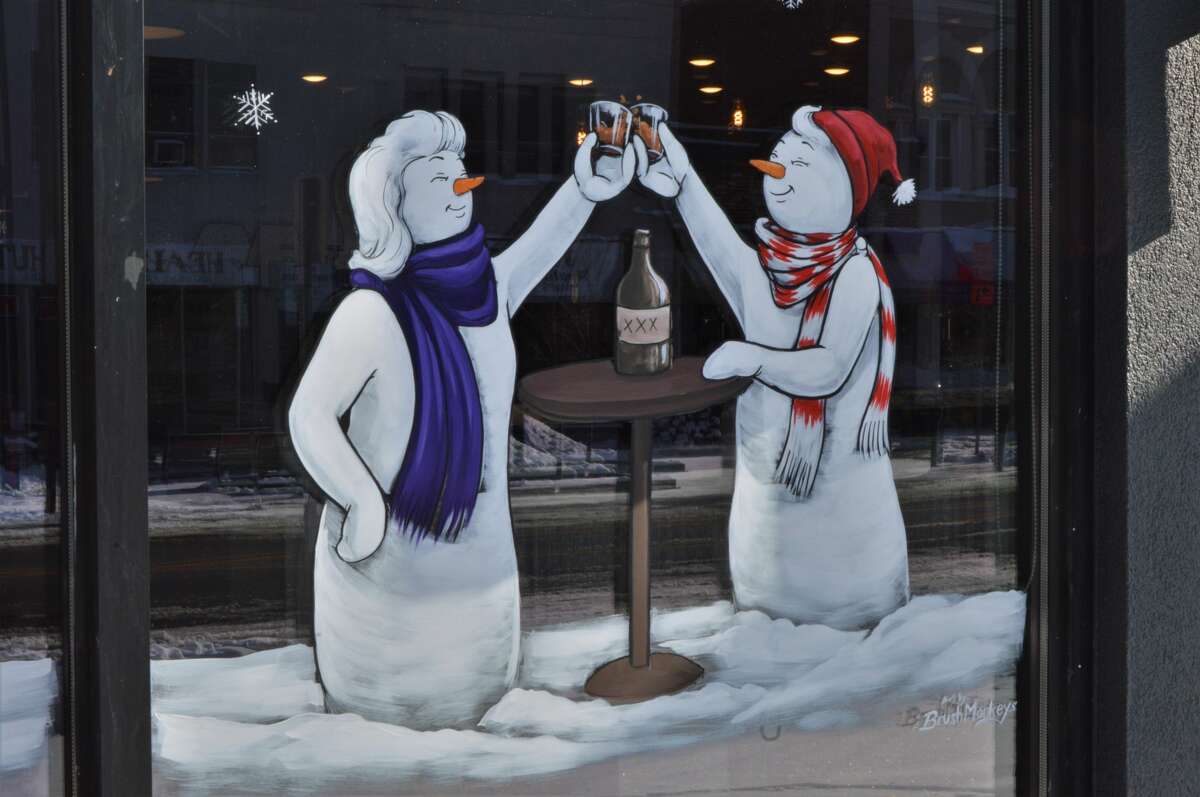 Downtown Midland has transformed into a winter wonderland with unified window paintings displayed on many of the storefronts and businesses along Main Street. Painted by a group called Brush Monkeys out of Ann Arbor, the paintings show whimsical wreaths and cheerful snowmen each with a personalized spin. (Ashley Schafer/Ashley.Schafer@hearstnp.com)