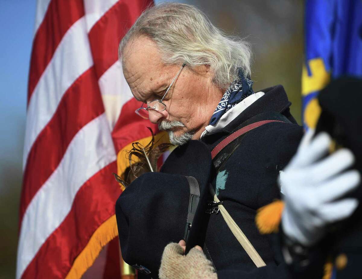 Martin Spring, of Waterbury, a member of the Ansonia/Derby chapter of the Sons of Union Veterans of the Civil War, bows his head during the annual Veterans Day ceremony at Veterans Memorial Park on Monday.