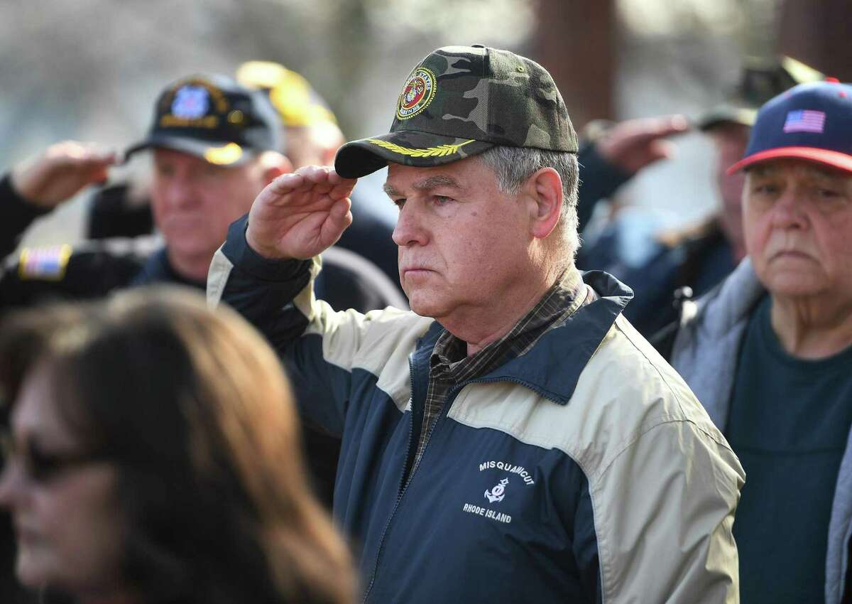 Vietnam Marine Corps veteran Joseph E. Bienkowski, center, of Shelton, salutes during the playing of taps at the annual Veterans Day ceremony at Veterans Memorial Park in Shelton, on Monday.