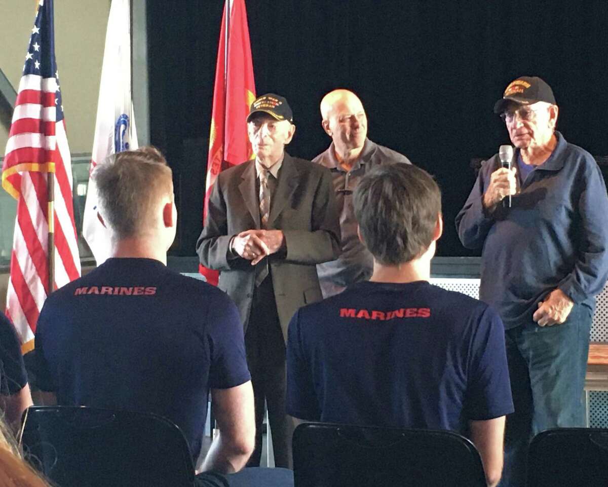 In the caps are World War II veterans Joseph Colwell and L.E. Millholland sharing advice with military recruits at the Nov. 10 Texans Embracing America's Military send-off. Between the veterans is Ralph Oliver, founder of TEAM Send-off Katy.