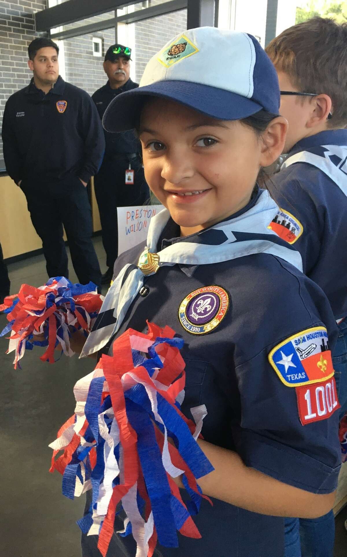 Cub Scout Foster Tujague, 8, of Pack 1001 was among those cheering new military recruits at the Texans Embracing America's Military send-off on Nov. 10 in Katy.