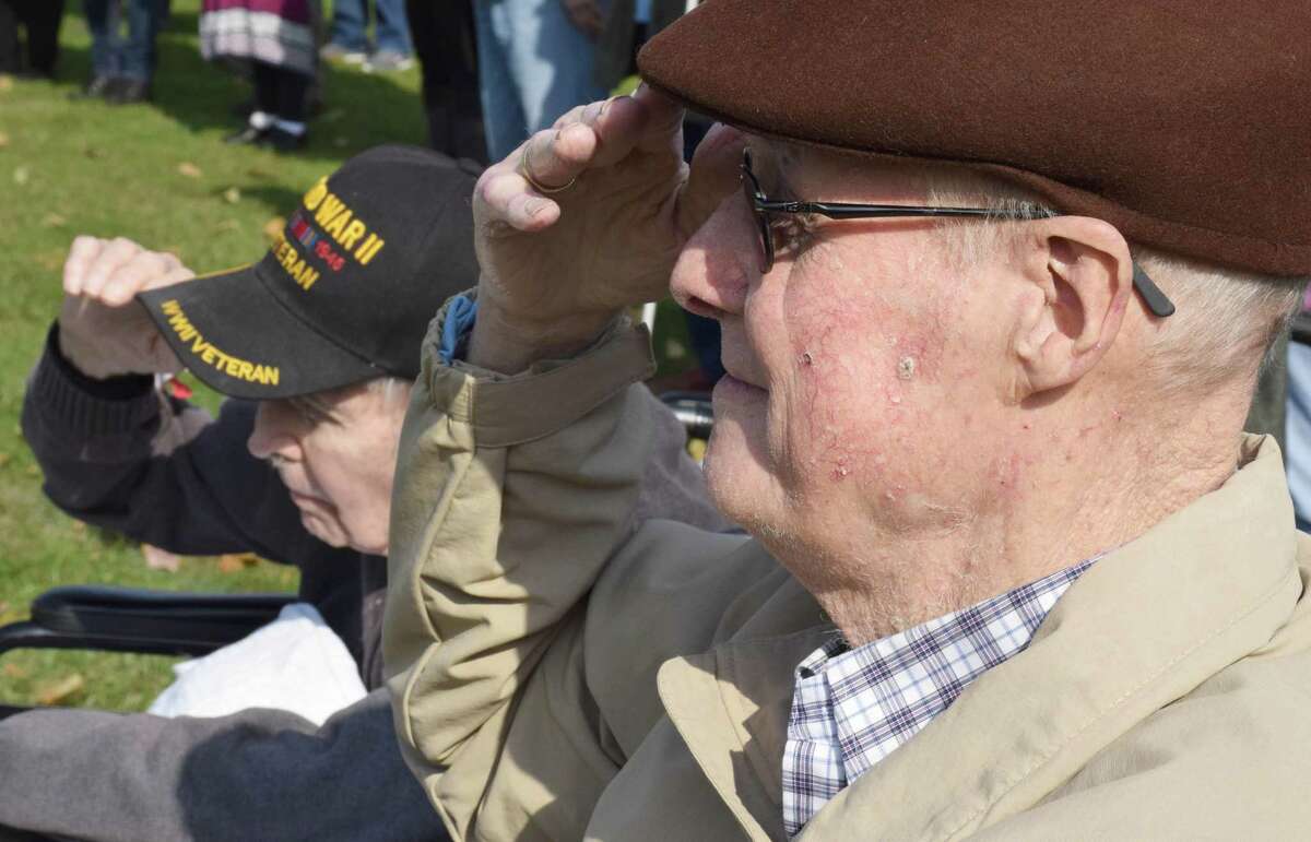 Veterans Michael Cherney, right, and Ed Tierney, both of Candlewood Valley Health & Rehabilitation, offer a salute during the National Anthem.
