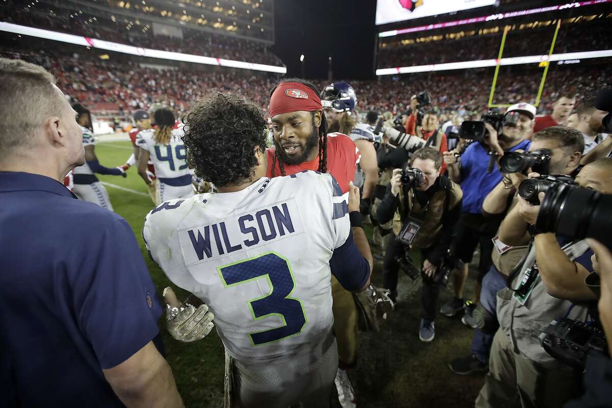 Seattle Seahawks quarterback Russell Wilson (3) greets San Francisco 49ers cornerback Richard Sherman after an NFL football game in Santa Clara, Calif., Monday, Nov. 11, 2019. The Seahawks won 27-24 in overtime. (AP Photo/Ben Margot)