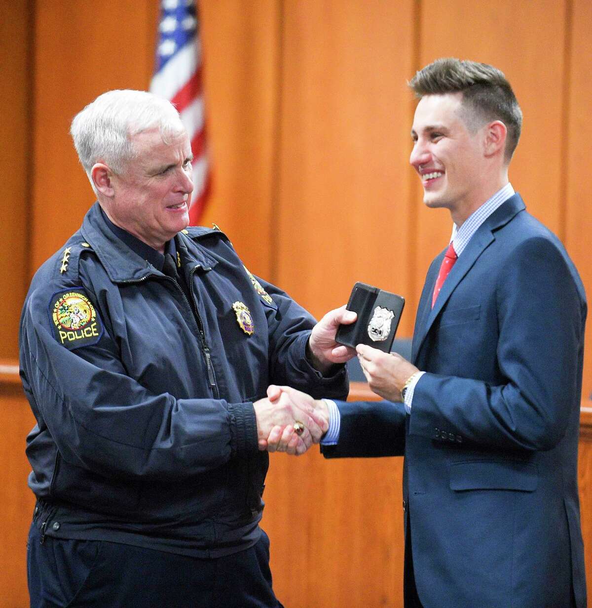 Greenwich Police Chief James Heavey officially hand Police Officer recruit Andrew Mitchell is badge on Nov. 12, 2019 in Greenwich, Connecticut after being sworn in at town hall by outgoing First Selectman Peter Tesei.