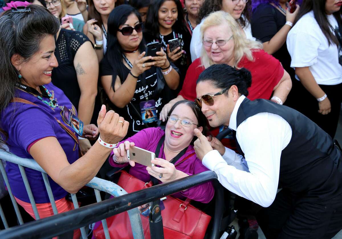 Chris Perez takes photos with fans during Madame Tussauds Hollywood's unveiling of GRAMMY award winner and cultural icon Selena Quintanilla immortalized in wax at Madame Tussauds on August 30, 2016 in Hollywood, California.
