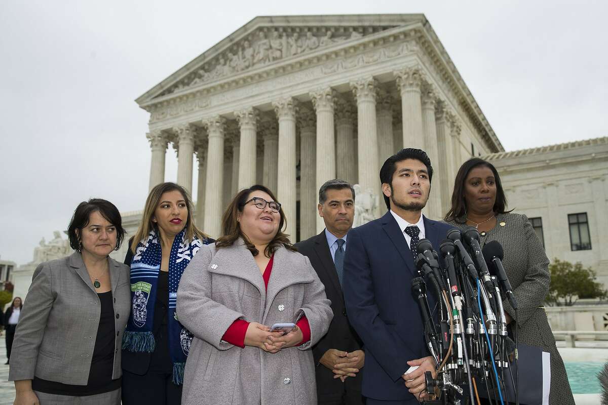 Deferred Action for Childhood Arrivals program recipient Jirayut "New" Latthivongskorn, second from right, speaks, accompanied by Eliana Fernandez, second from left, Greisa Martinez Rosa, California Attorney General Xavier Becerra and New York Attorney General Letitia James after leaving the Supreme Court after oral arguments were heard in the case of President Trump's decision to end the Obama-era, (DACA), Tuesday, Nov. 12, 2019, at the Supreme Court in Washington. (AP Photo/Alex Brandon)