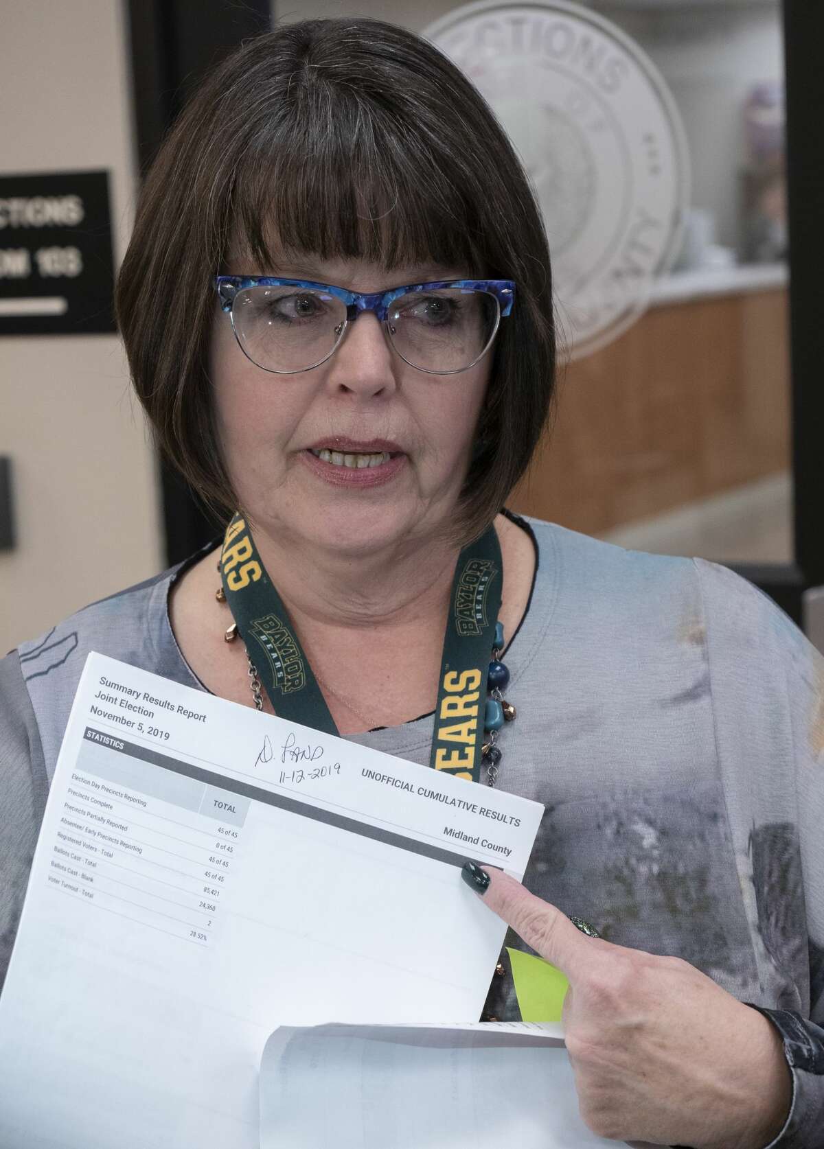 Deborah Land, Midland County Elections Administrator, gives the final vote tally for the MISD Bond 11/12/19 evening outside the elections office. Tim Fischer/Reporter-Telegram